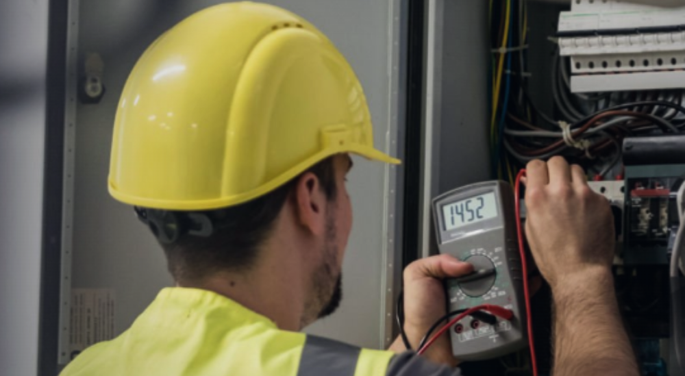 Electrician testing a meterboard with a multimeter